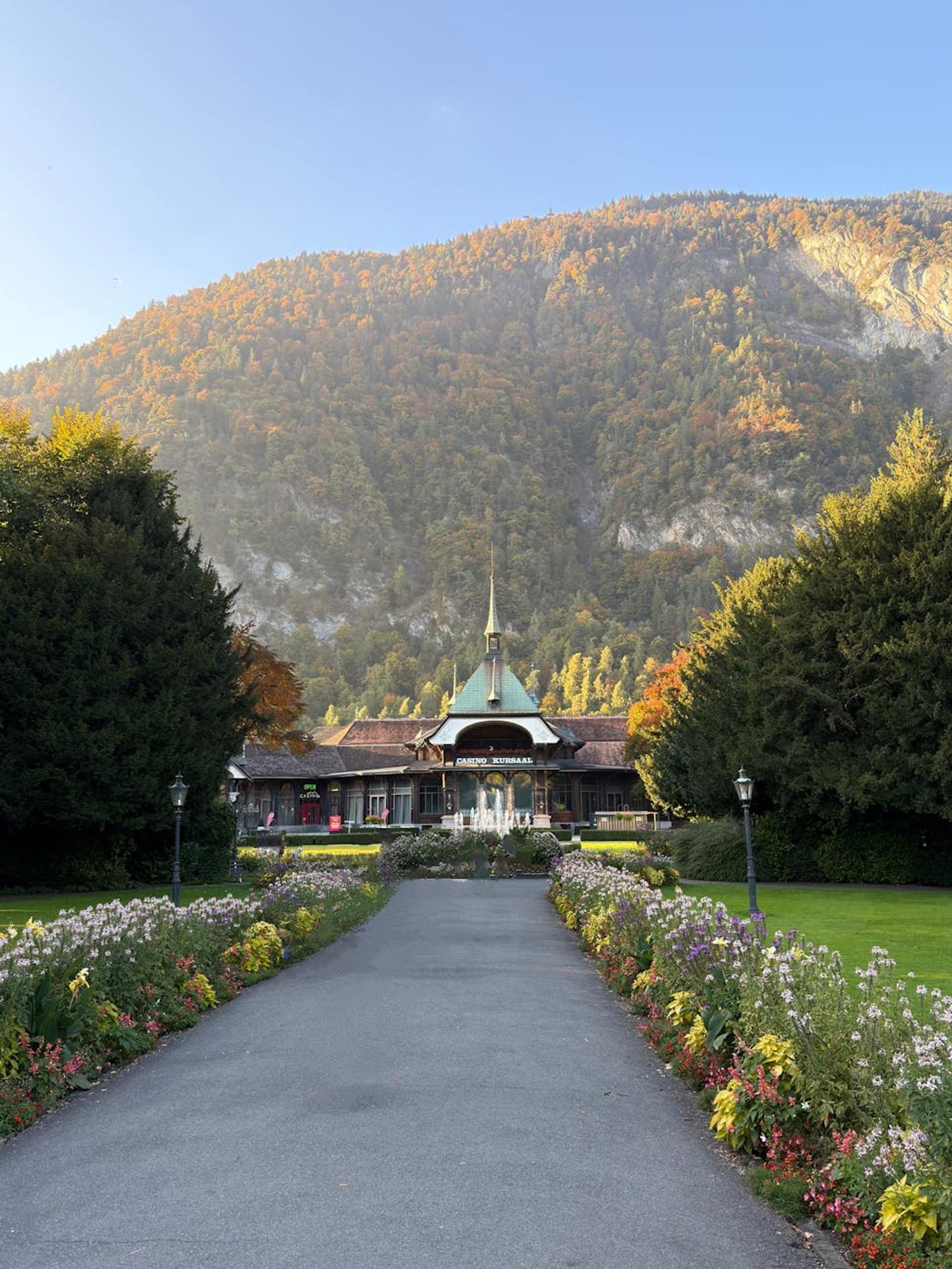 Garden path lined with flowers leading to a domed pavilion at dusk