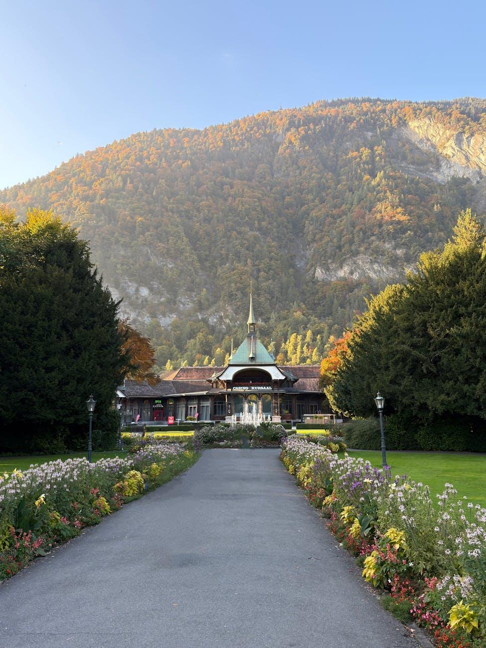 Garden path lined with flowers leading to a domed pavilion at dusk
