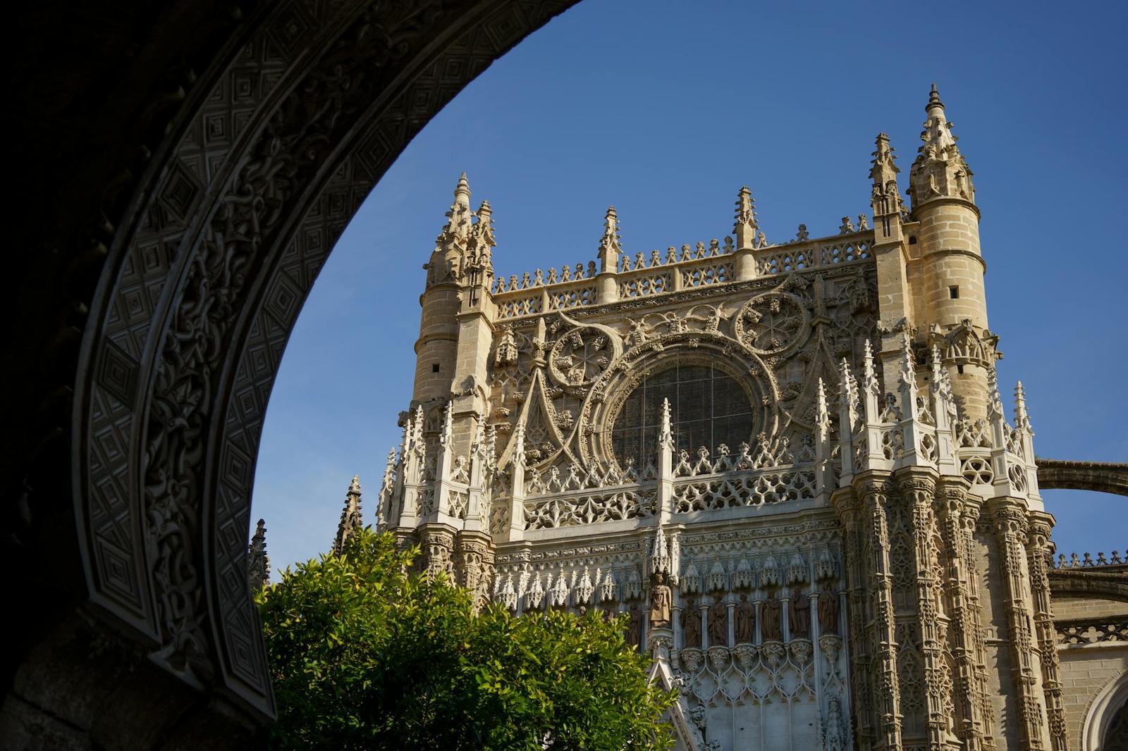 Explore the intricate gothic architecture of Seville Cathedral's facade with its stunning details