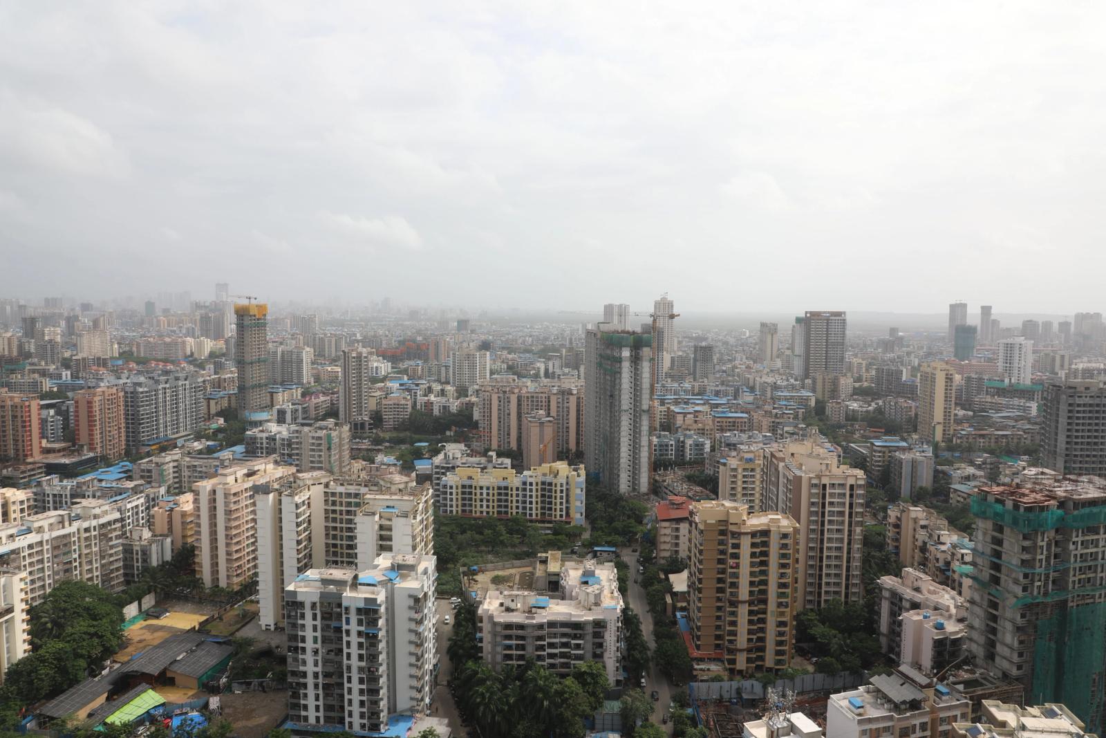 Vast urban skyline filled with high-rise buildings and cloudy sky