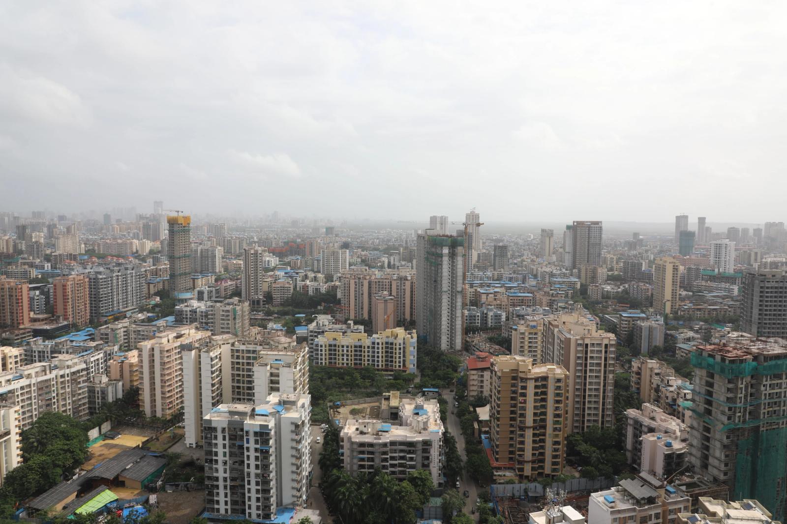 Vast urban skyline filled with high-rise buildings and cloudy sky