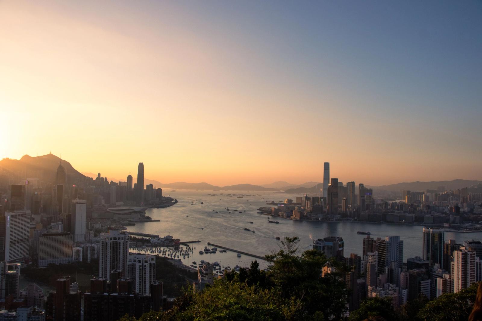 A breathtaking view of Hong Kong's skyline and harbor at sunset, capturing urban beauty