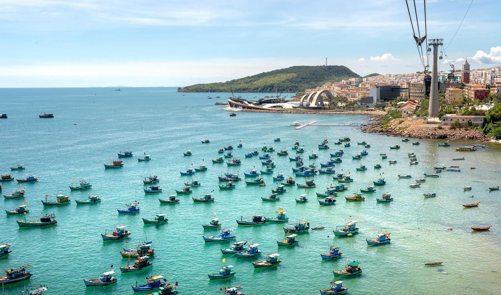 Harbor crowded with dozens of small fishing boats from a cable car view