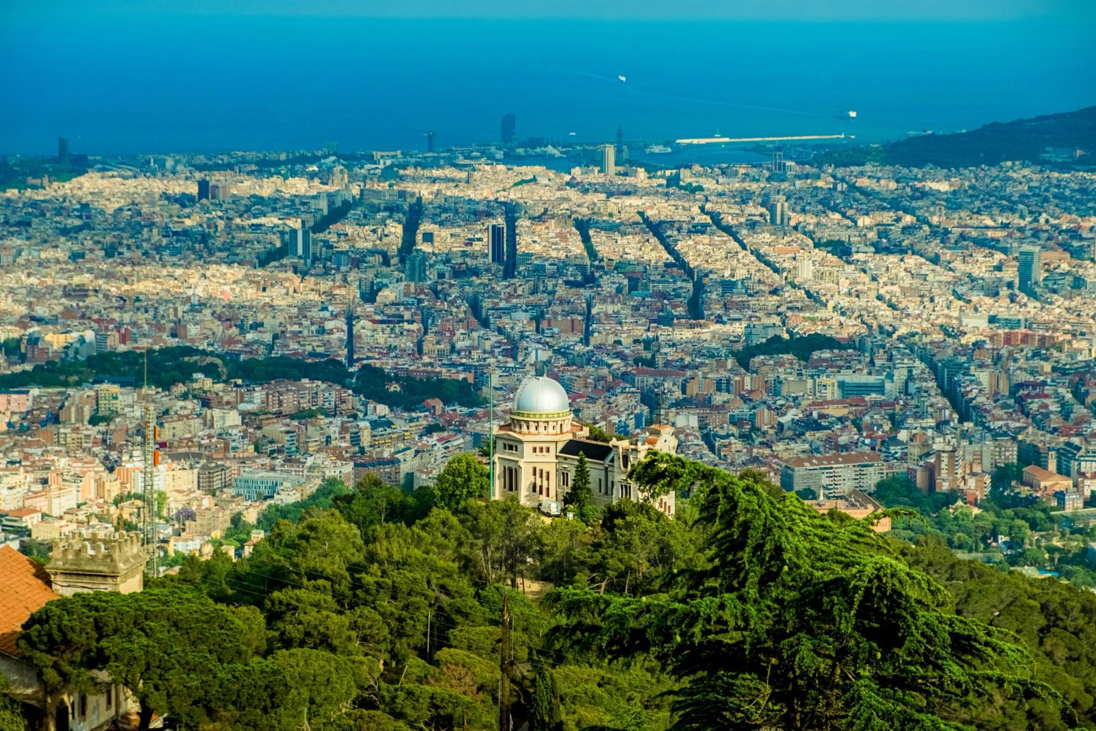 Stunning aerial shot of Barcelona cityscape with the iconic Fabra Observatory in the foreground