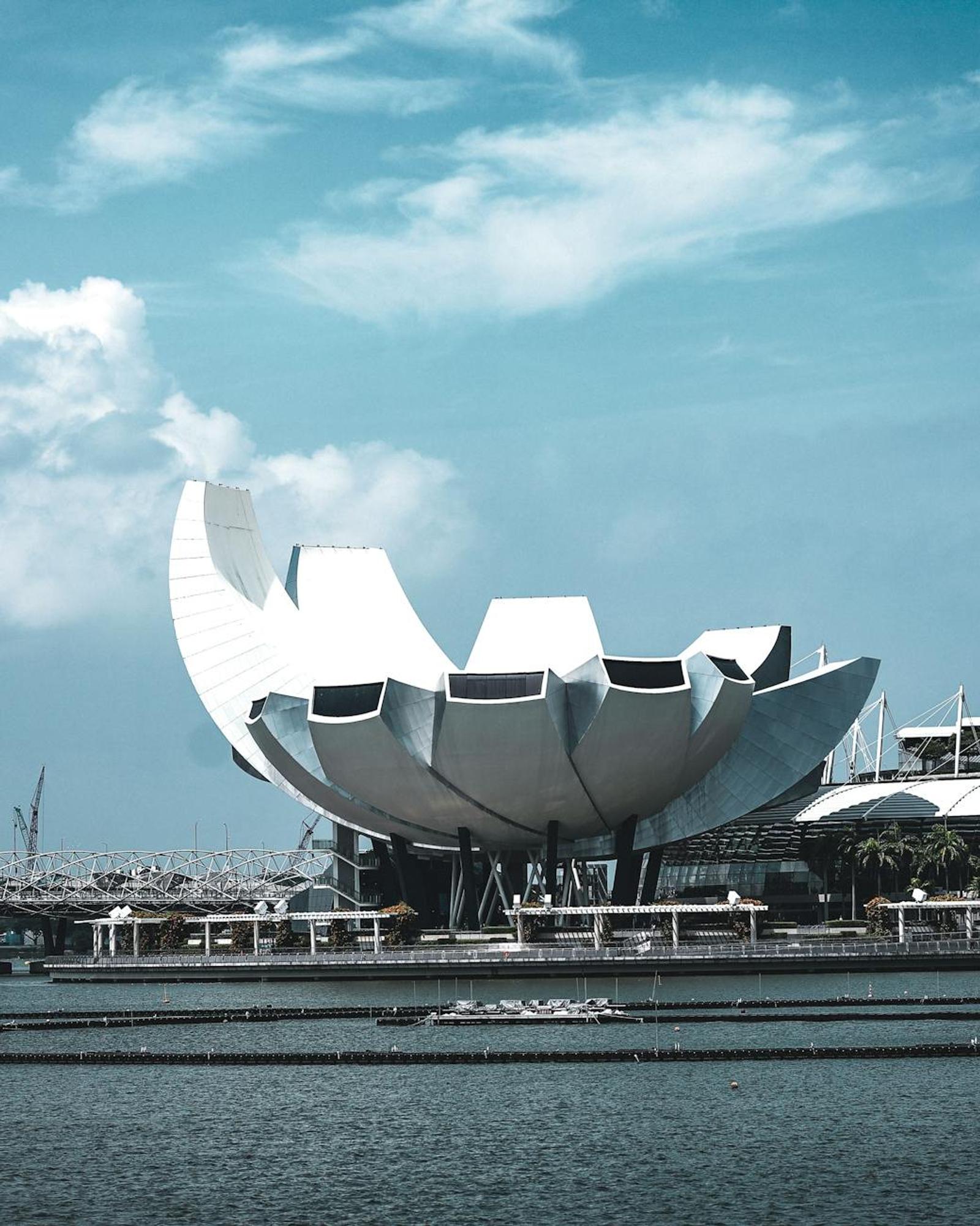 The iconic ArtScience Museum in Marina Bay, Singapore under a bright blue sky