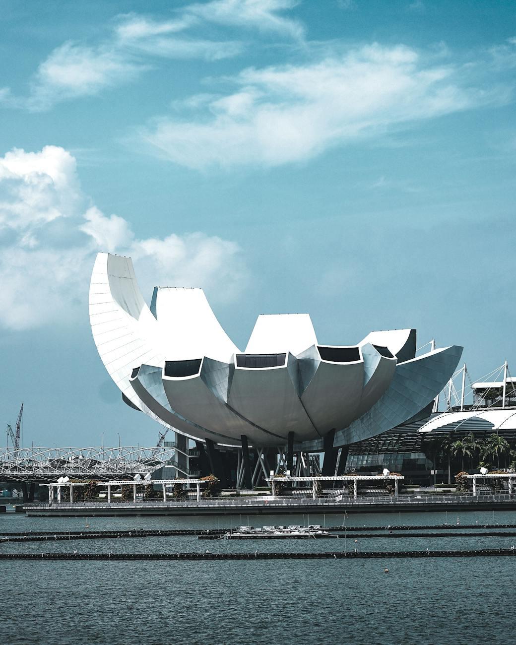 The iconic ArtScience Museum in Marina Bay, Singapore under a bright blue sky