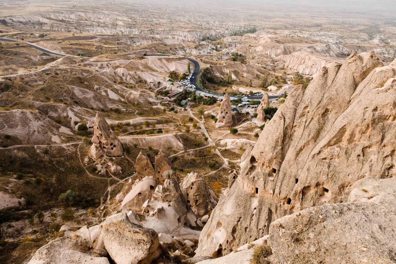 Explore the stunning rocky formations of Cappadocia, Turkey, captured from above with a scenic vista of the arid landscape