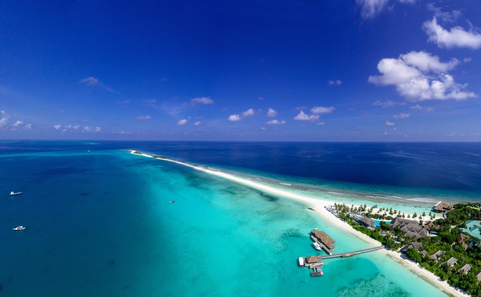 Stunning aerial view of a tropical island in the Maldives with pristine beaches and clear blue waters