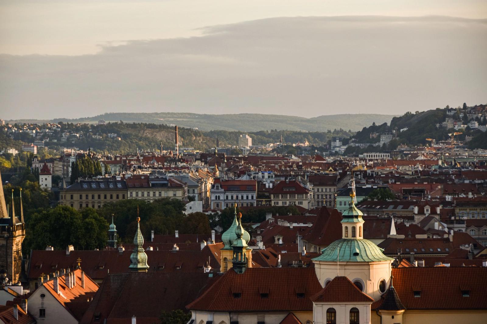 Stunning aerial view of Prague's historic cityscape at sunset, showcasing iconic architecture