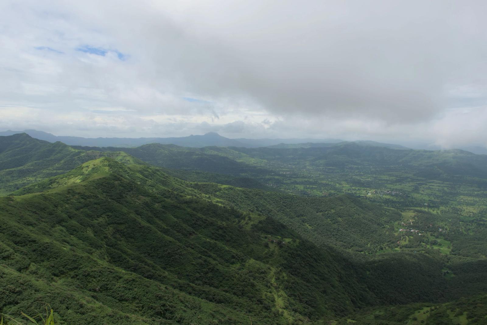 Experience the lush green Sahyadri Mountains in Pune, India, enveloped by monsoon clouds