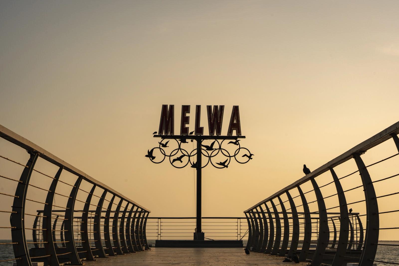 Silhouette of the Melwa sign at Colombo's pier during sunset, Sri Lanka