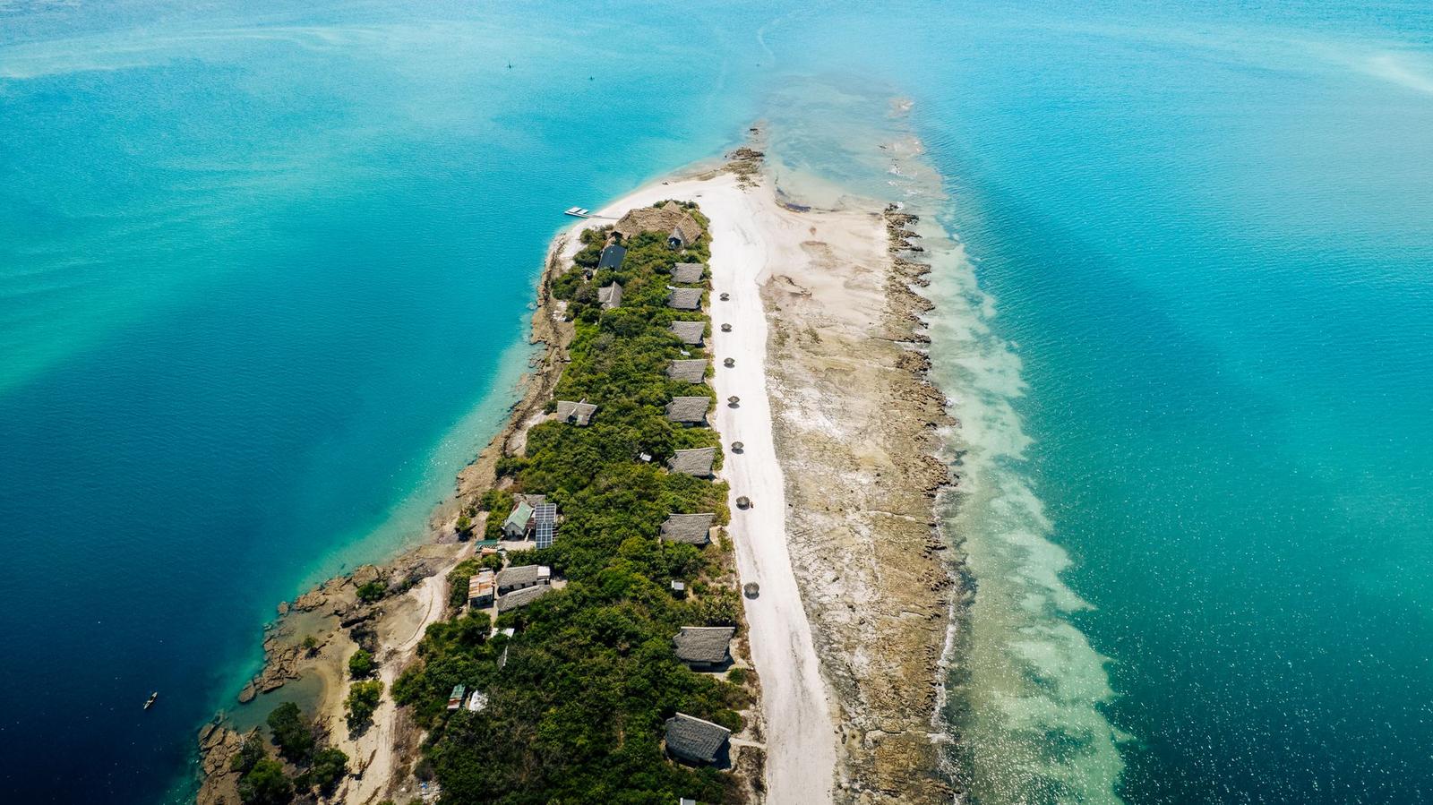 Stunning aerial photo of a coastal island surrounded by clear turquoise waters