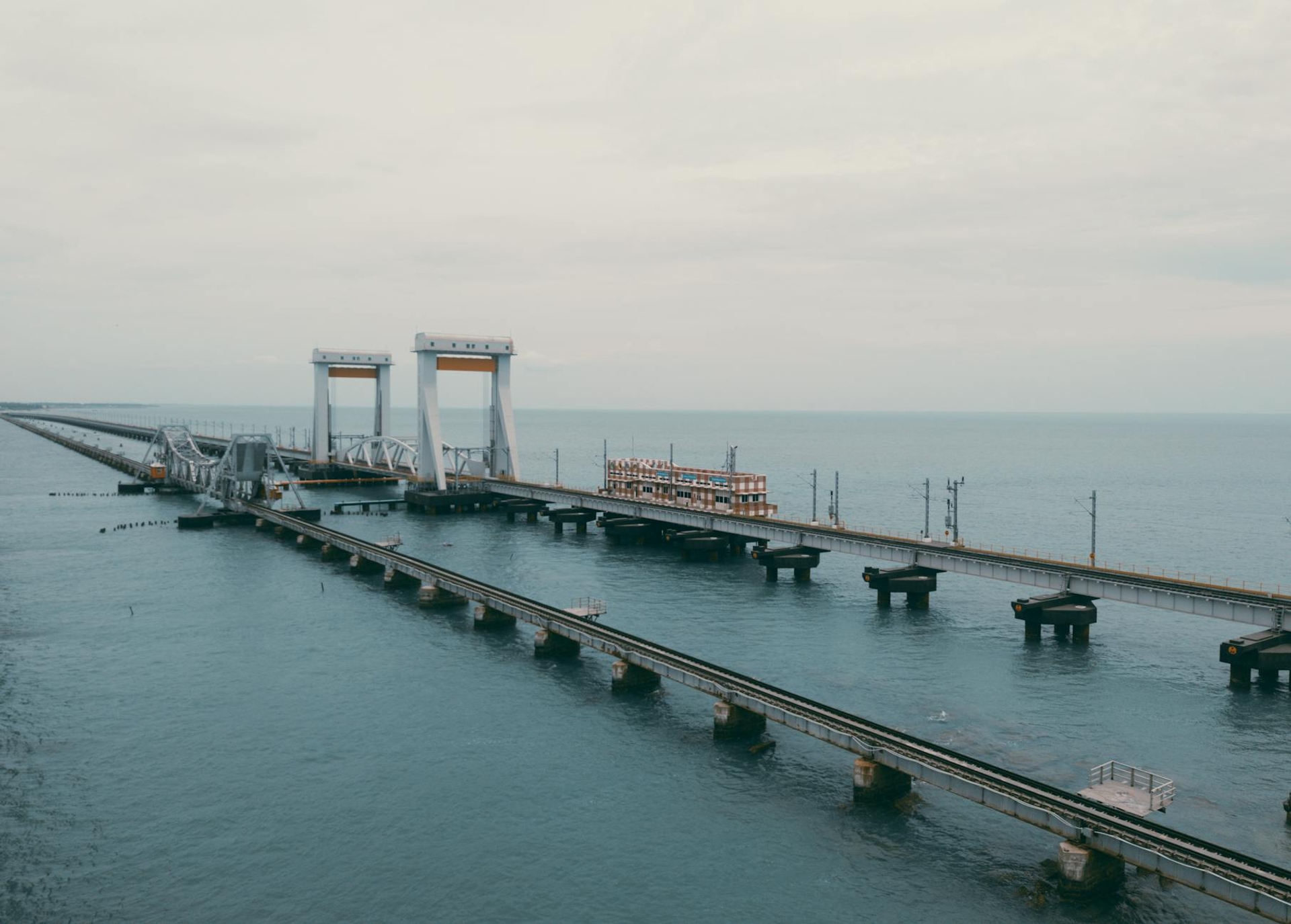 A long sea bridge with a raised lifting span over calm water