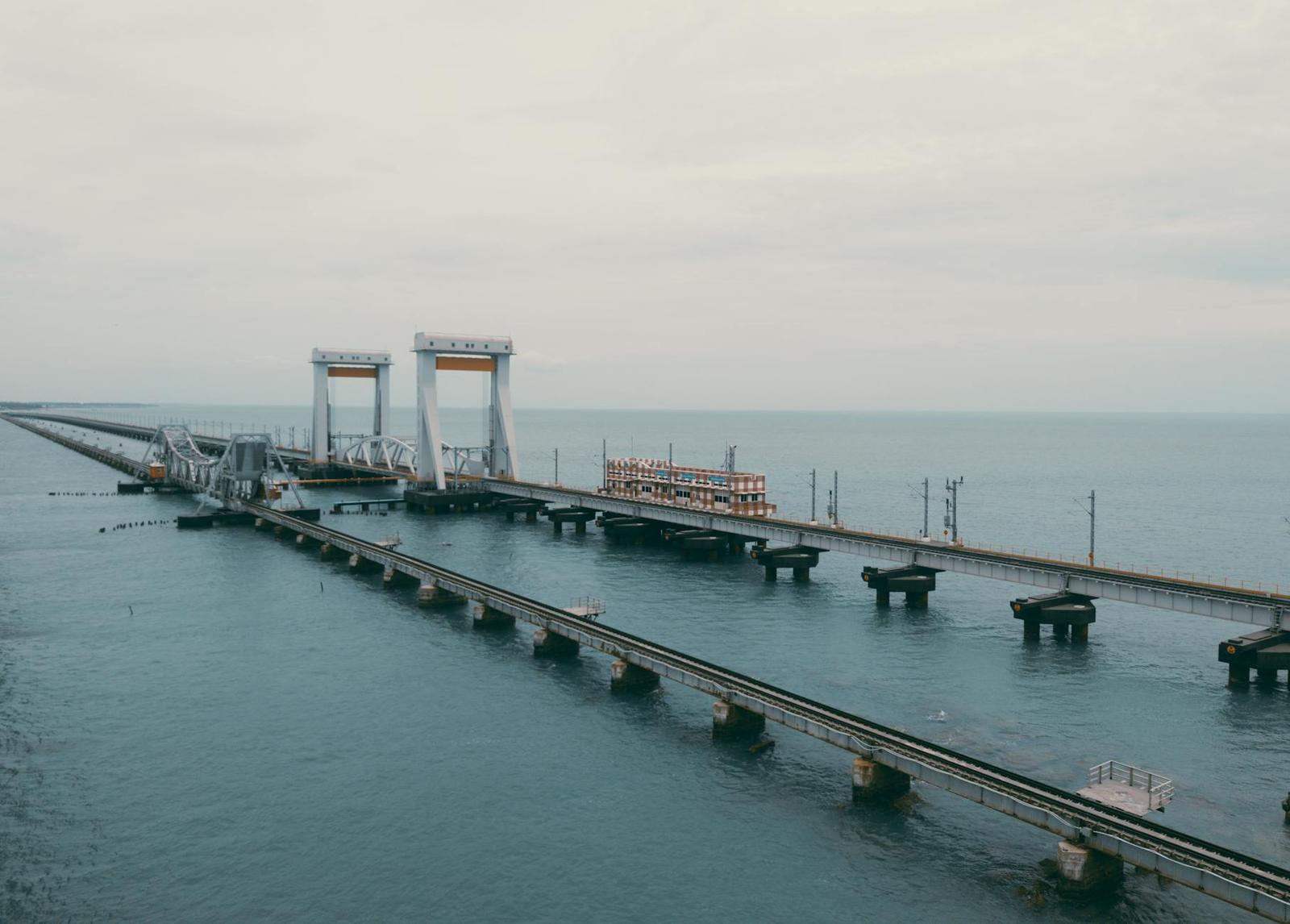 A long sea bridge with a raised lifting span over calm water