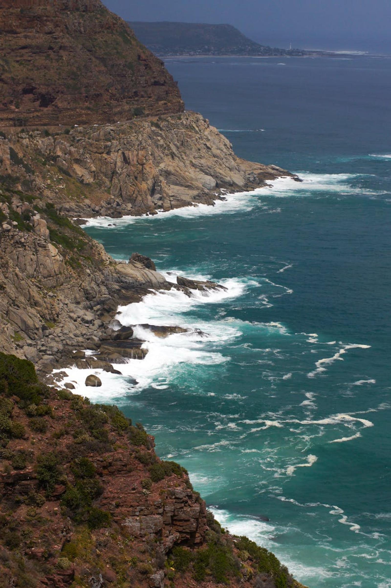 Rugged rocky coastline with waves crashing against cliffs