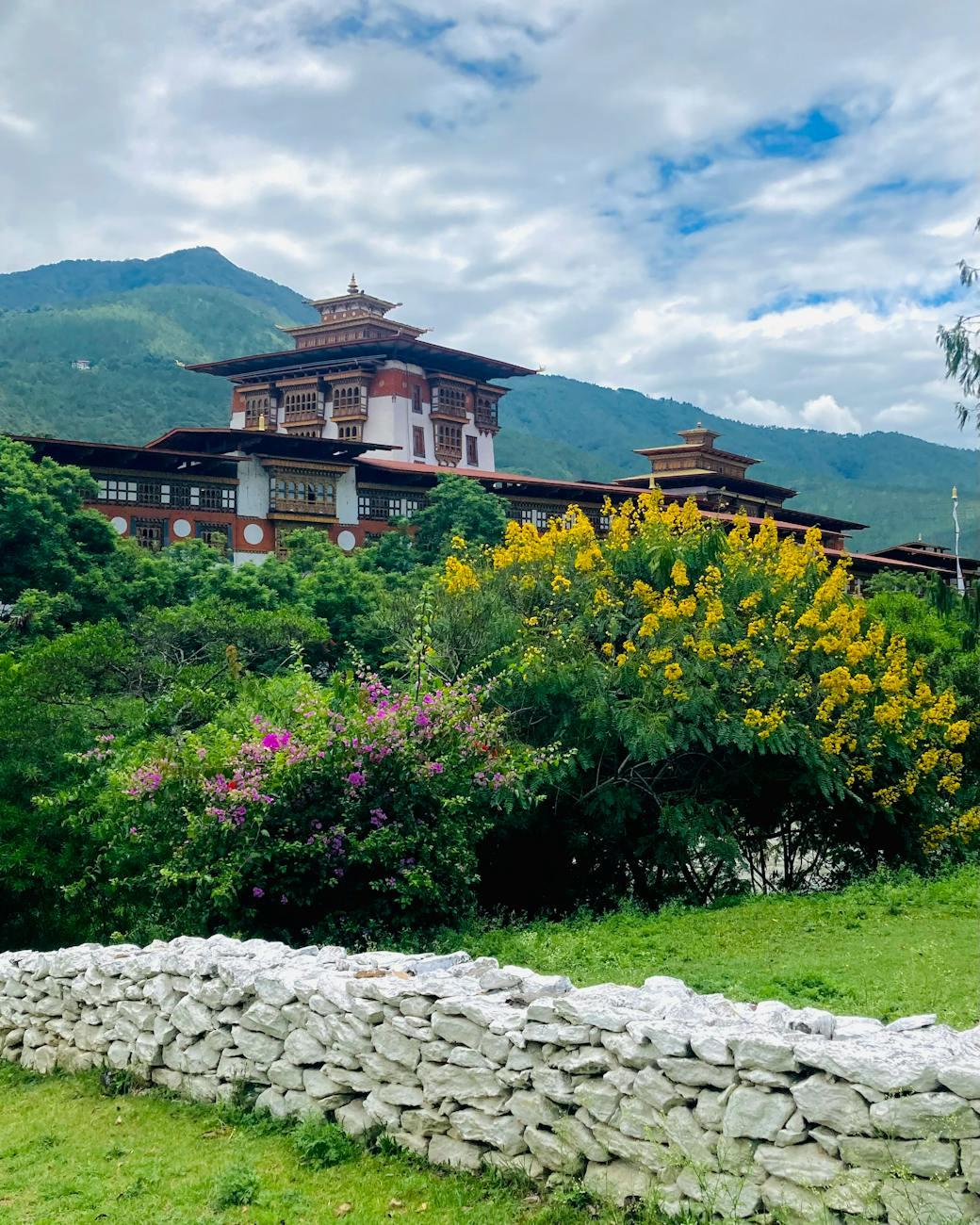 Beautiful view of Punakha Dzong surrounded by lush greenery and vibrant flowers in Bhutan