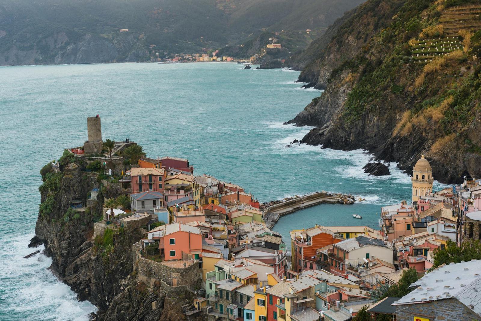 A colourful cliffside fishing village overlooking a small harbour