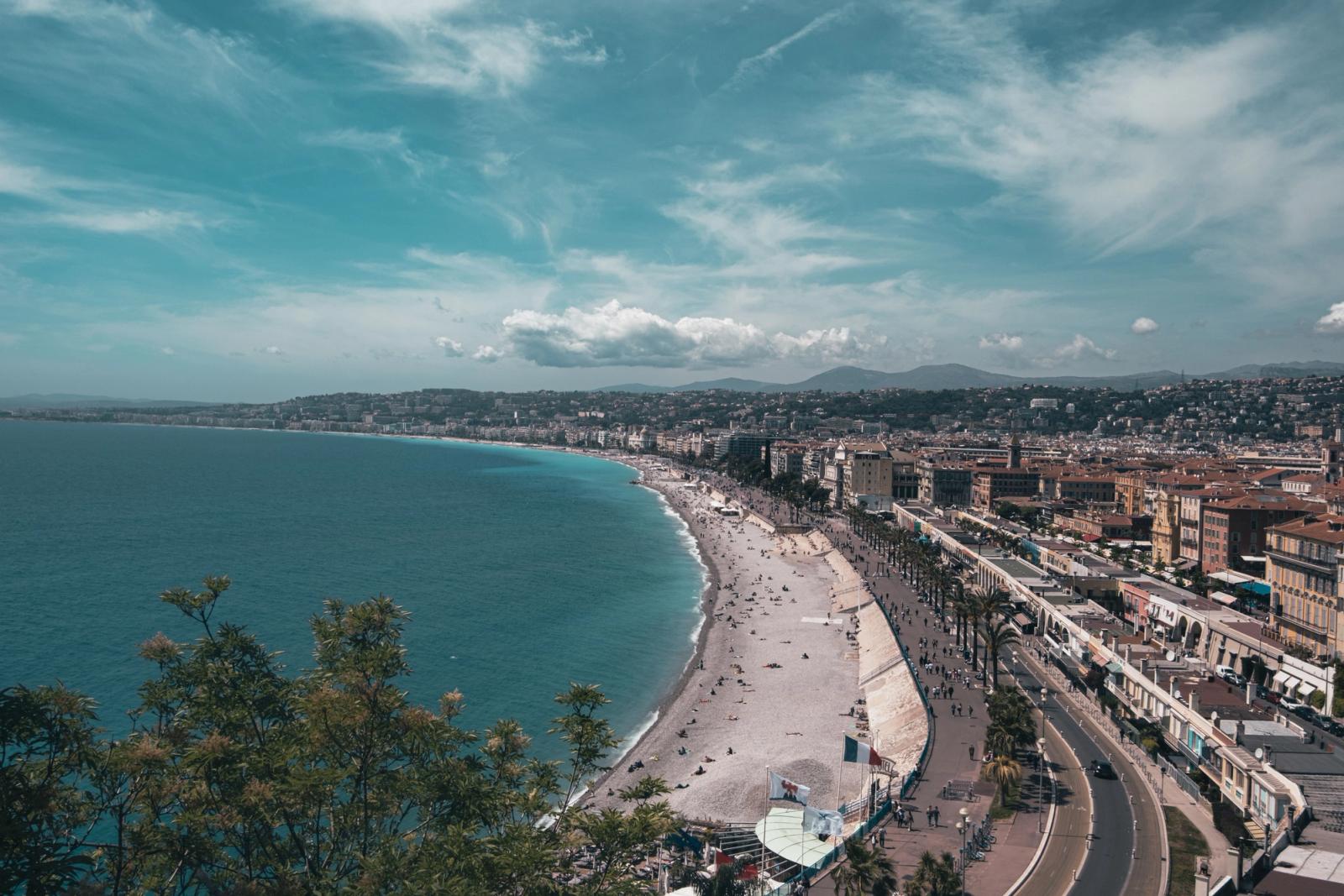 Stunning aerial view of Nice, France with bustling beachfront under a clear summer sky