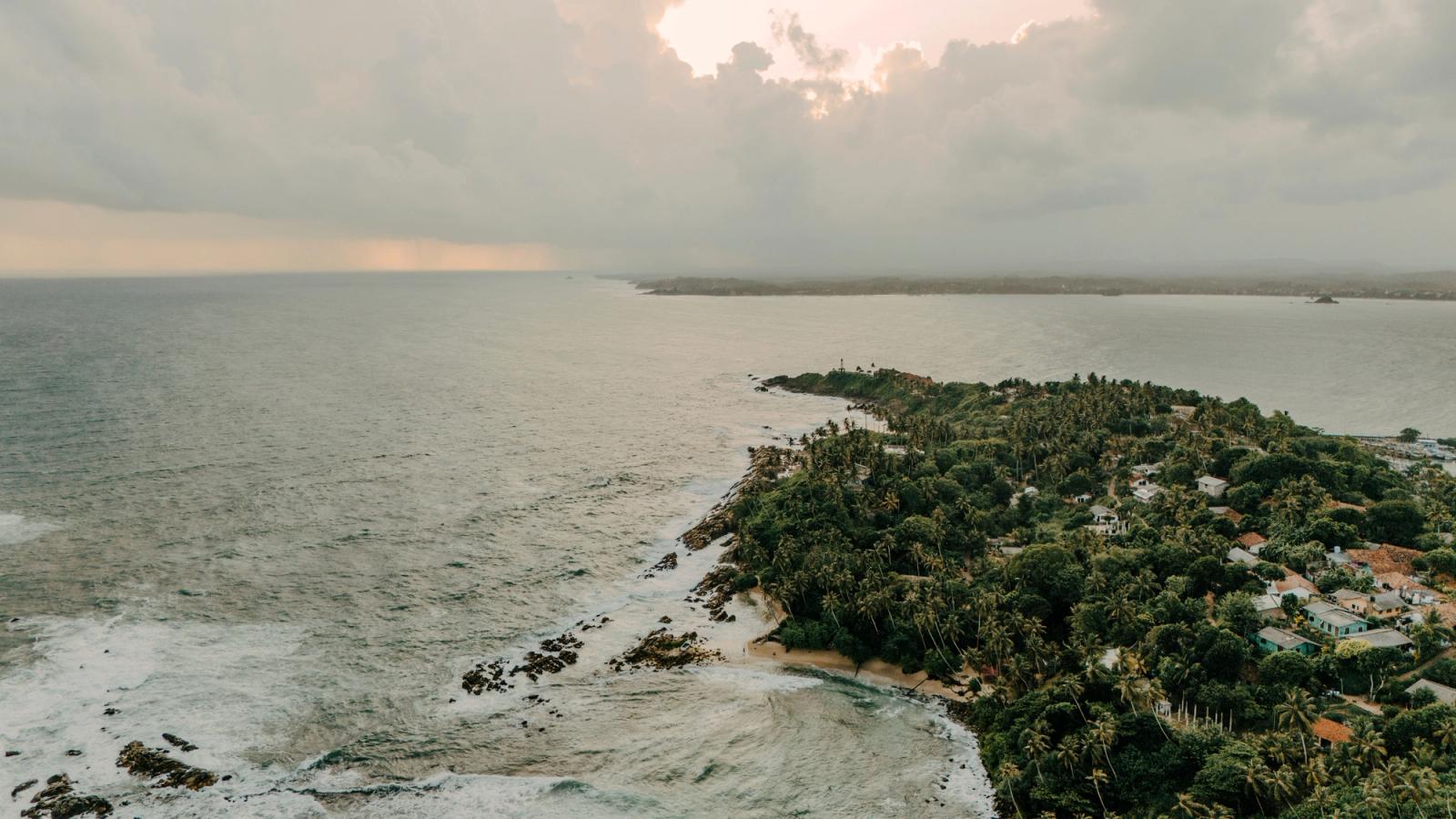Captivating aerial view of Sri Lanka's lush coastline during a tranquil sunset