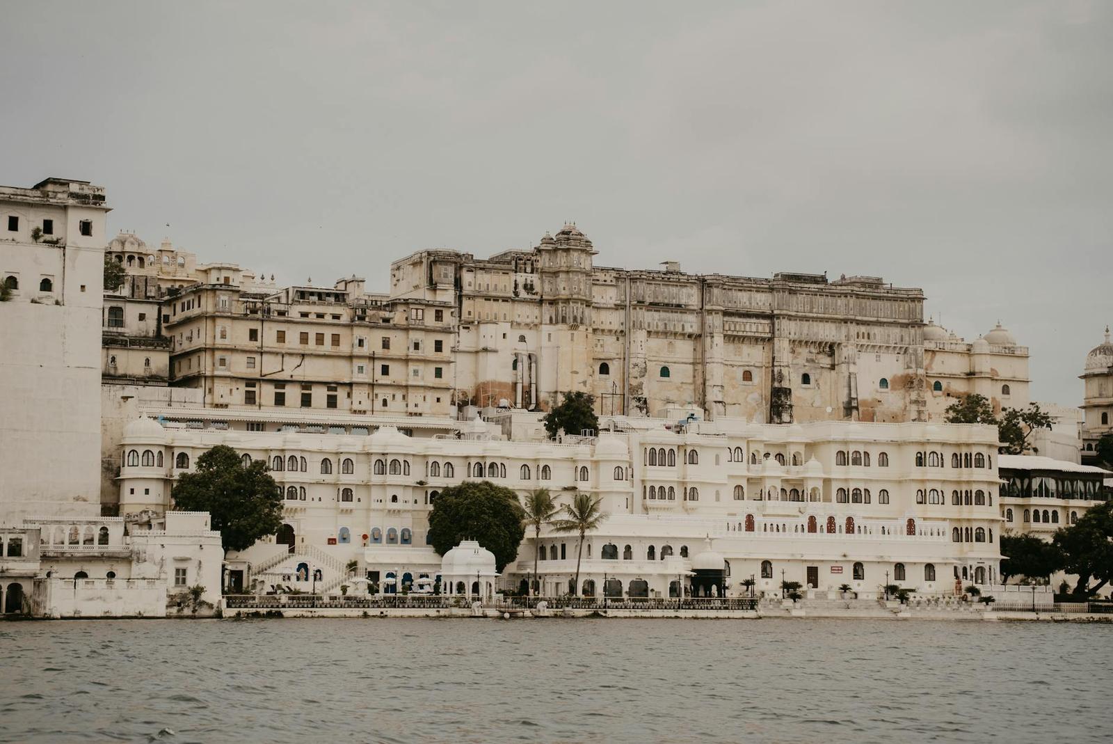 A sprawling white lakeside palace complex rising above the water