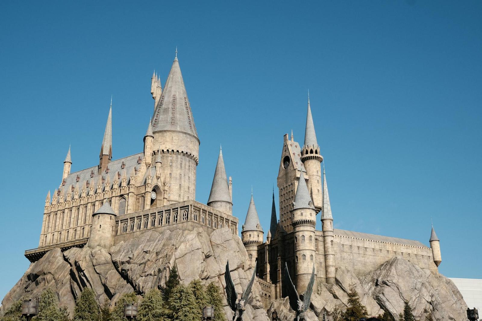 A fantastical stone castle with spired turrets atop a rocky outcrop