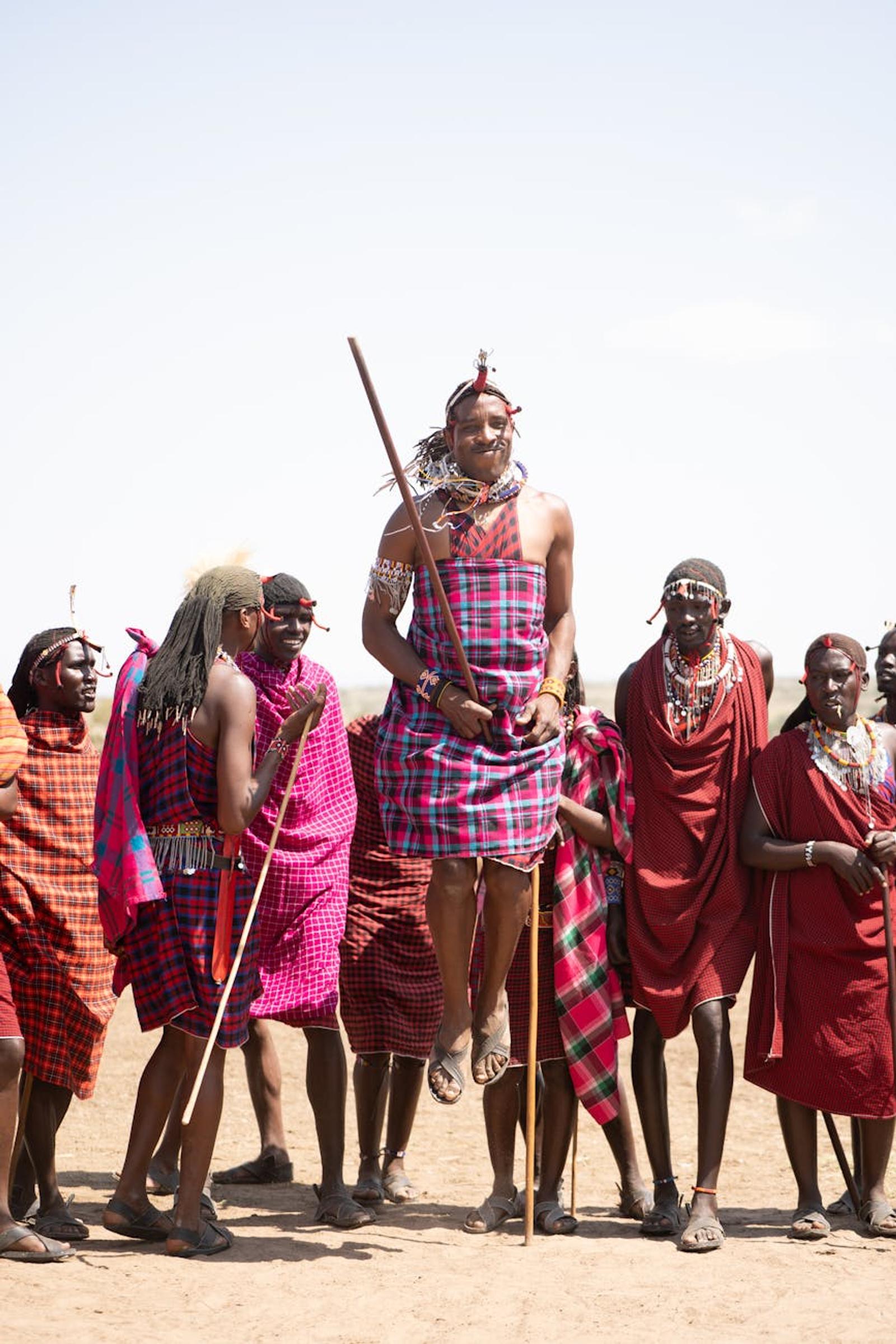 Maasai man leaping mid-air during a traditional jumping dance with his group