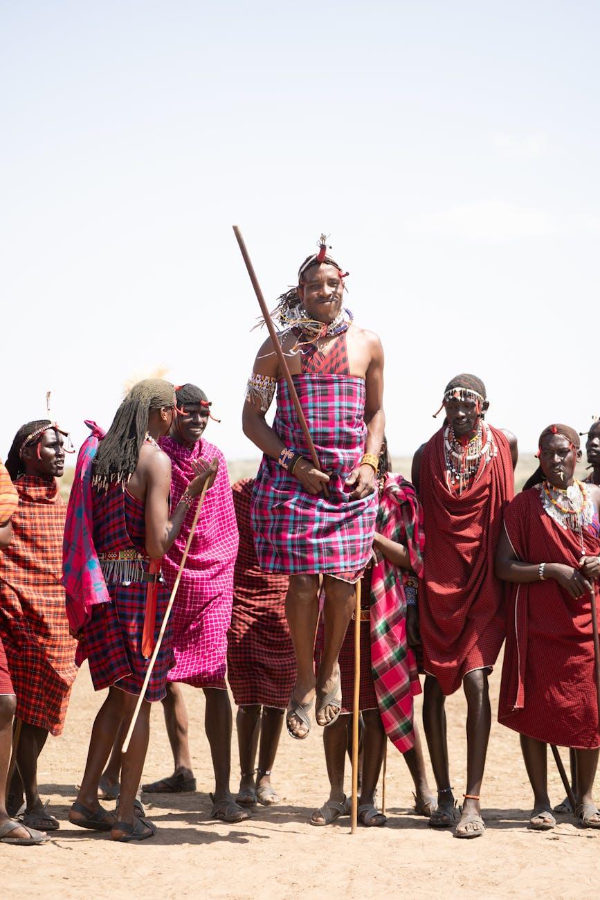 Maasai man leaping mid-air during a traditional jumping dance with his group