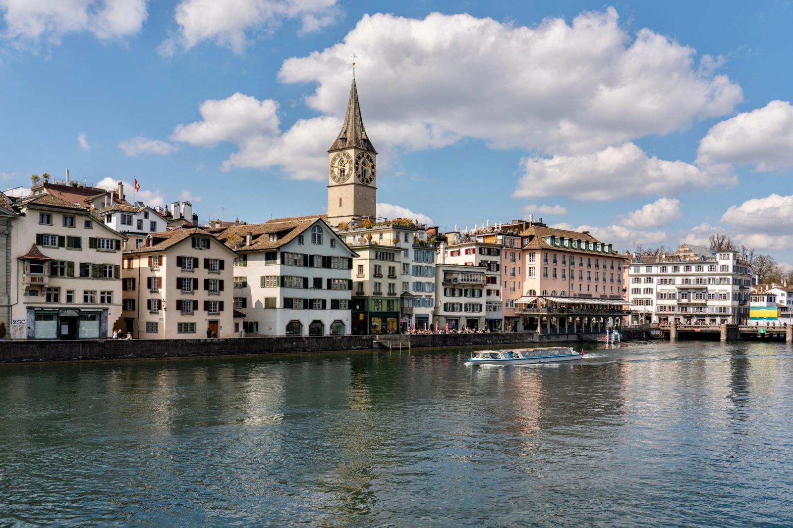 Scenic view of St. Peter's Church by the Limmat River in Zurich, Switzerland