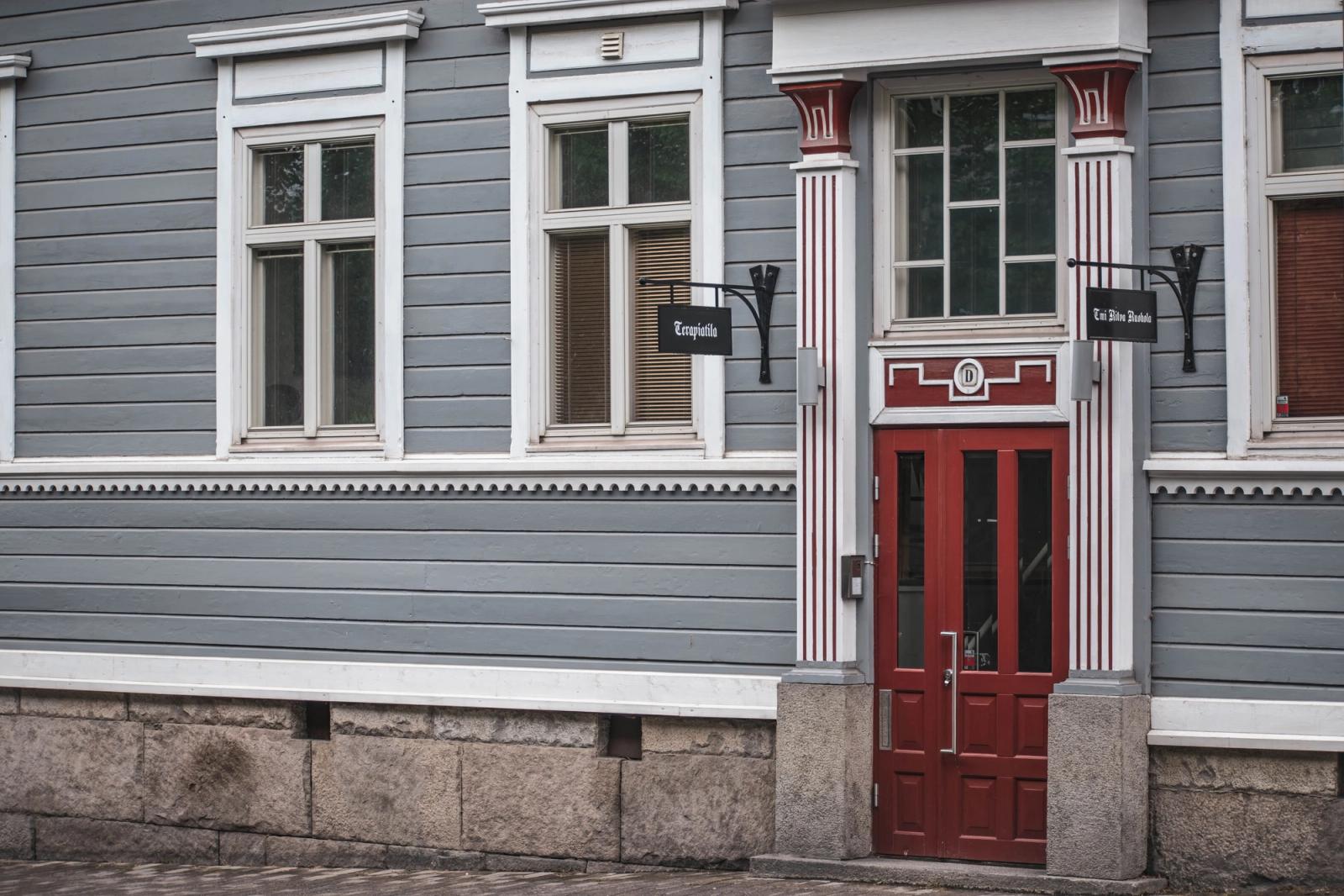 Vintage building facade with red door in Tampere, Finland. Classic Nordic architecture