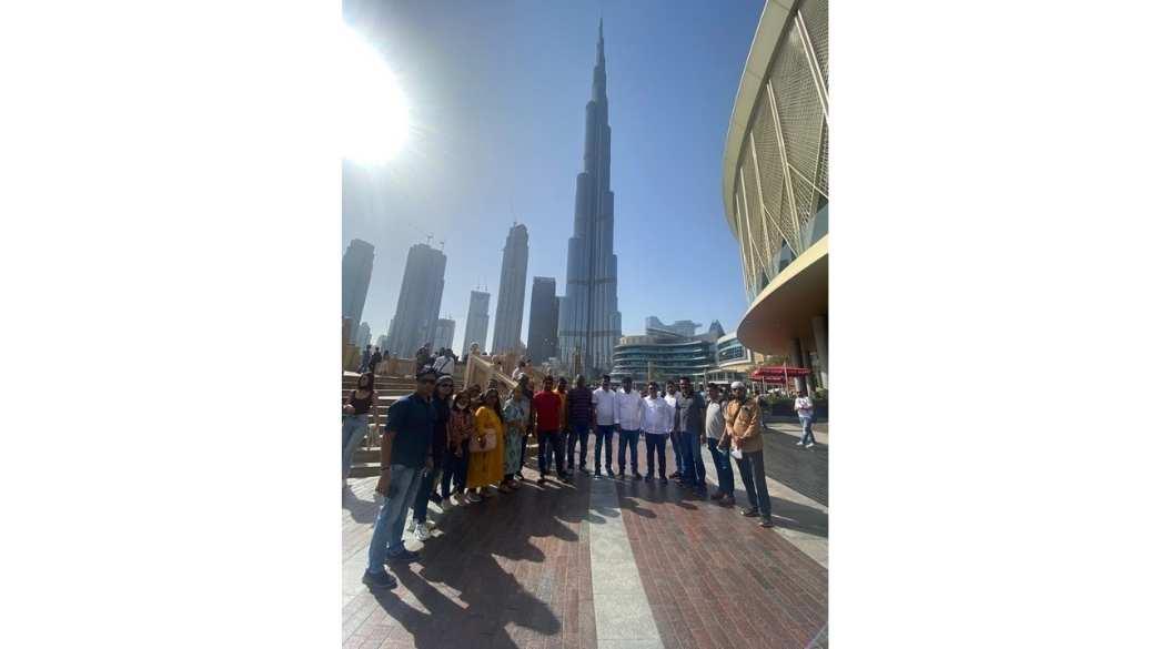 Group of people posing in front of the Burj Khalifa in Dubai