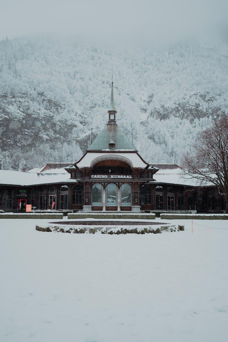 Snow-covered Casino Kursaal in Interlaken, Switzerland, surrounded by winter mountains