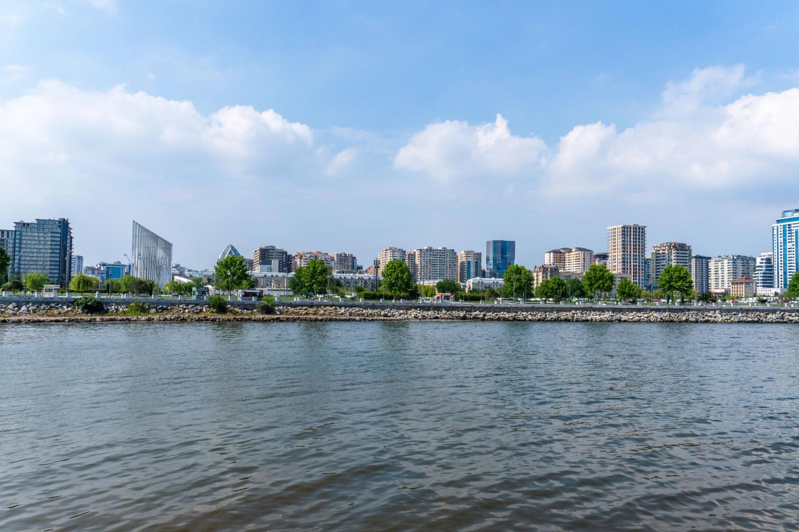 Beautiful skyline of Baku city with modern architecture by the Caspian Sea under a blue sky