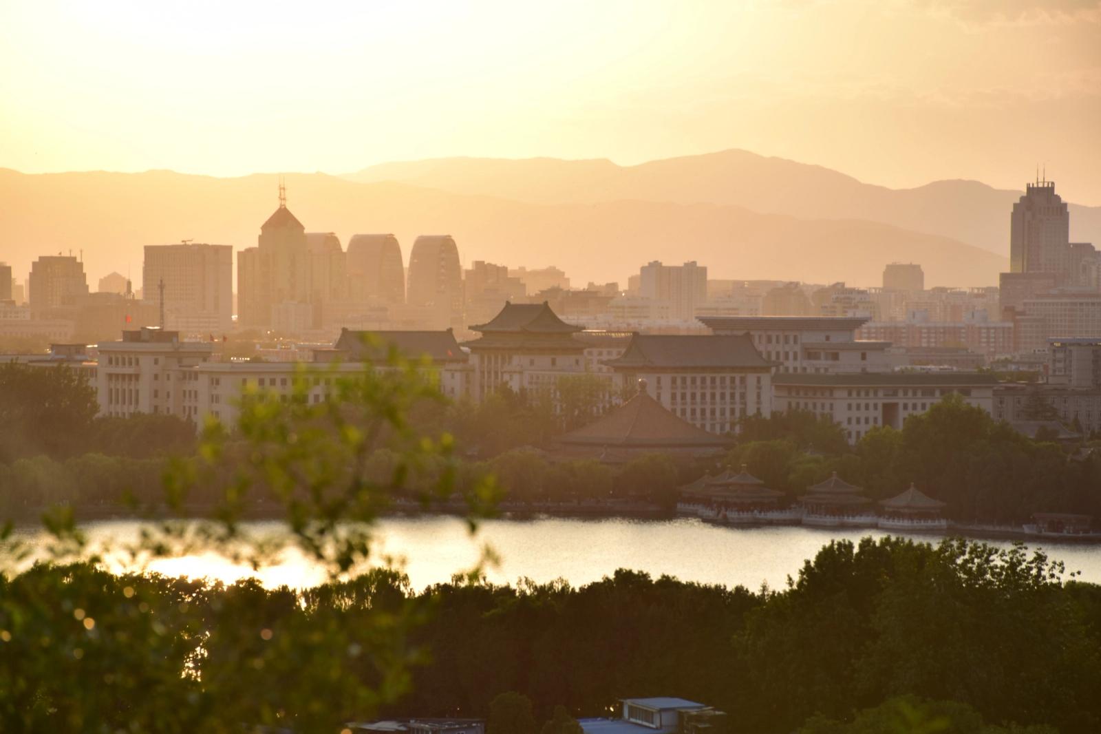 Capture of Beijing's cityscape with a serene sunset and iconic architecture