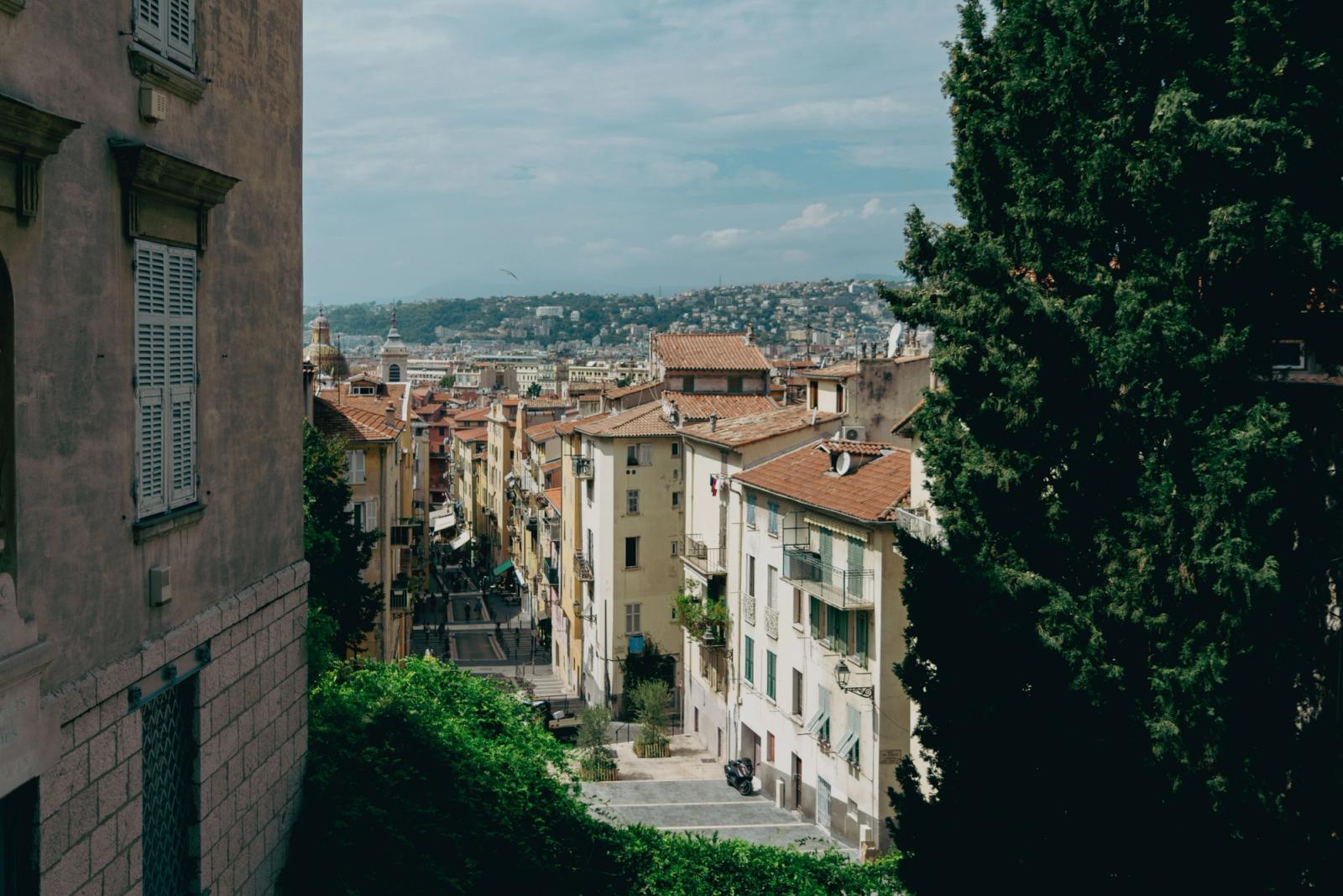 Explore the picturesque streets of Nice with historic architecture and stunning hillside views
