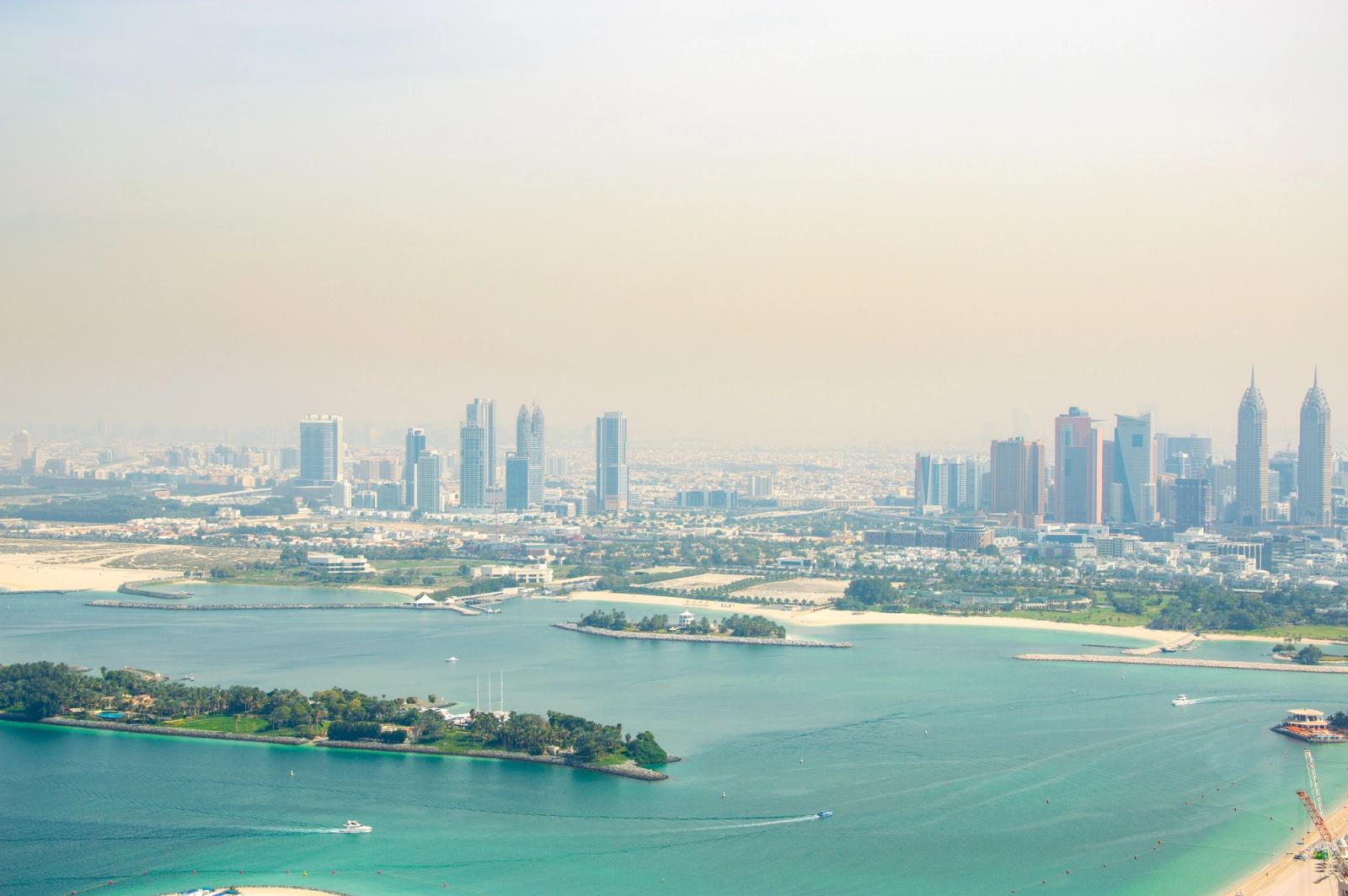 Stunning aerial view of Dubai's skyline with pristine coastline and turquoise waters