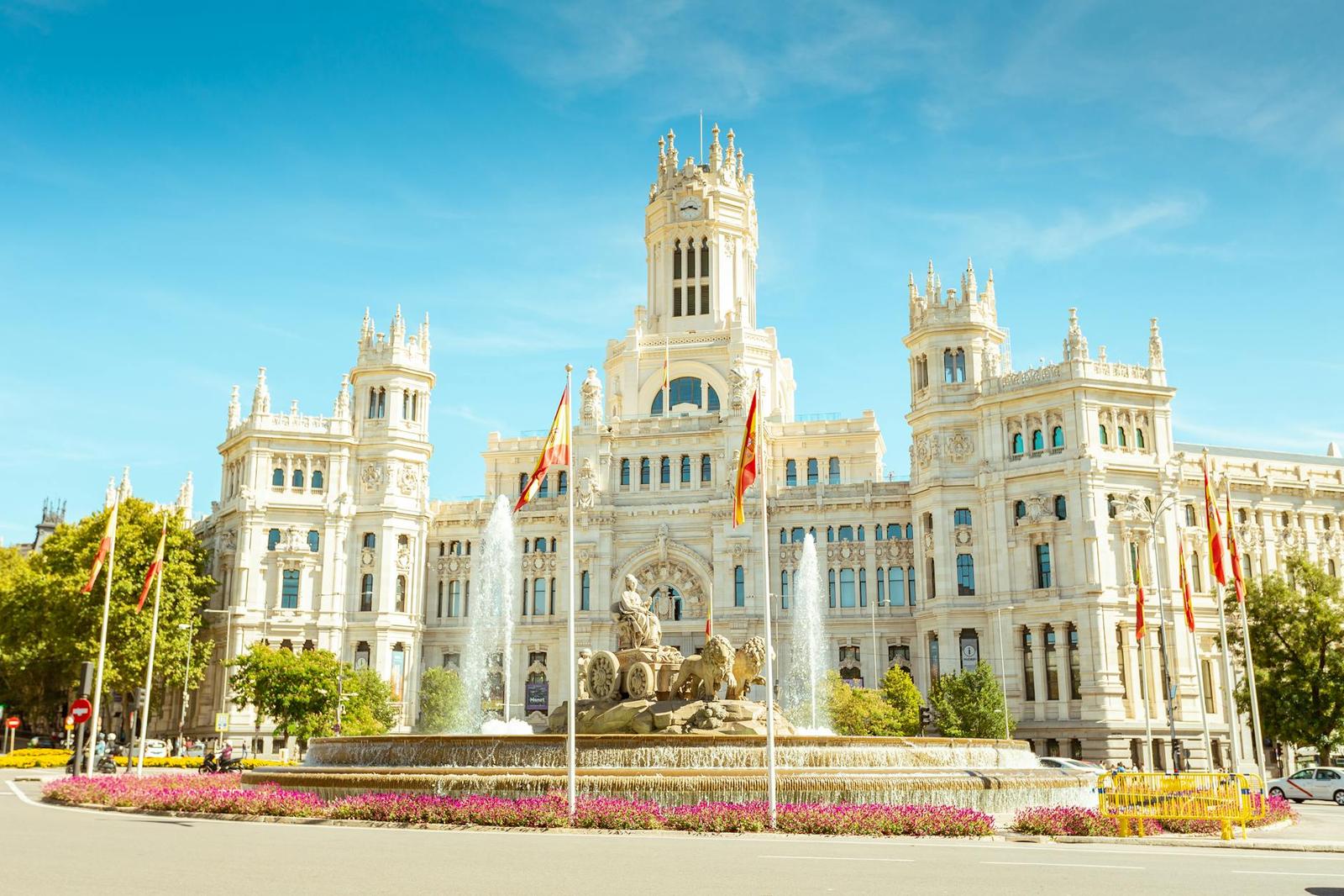 Iconic view of the Cibeles Fountain and Palace, a landmark in central Madrid, Spain, under clear skies