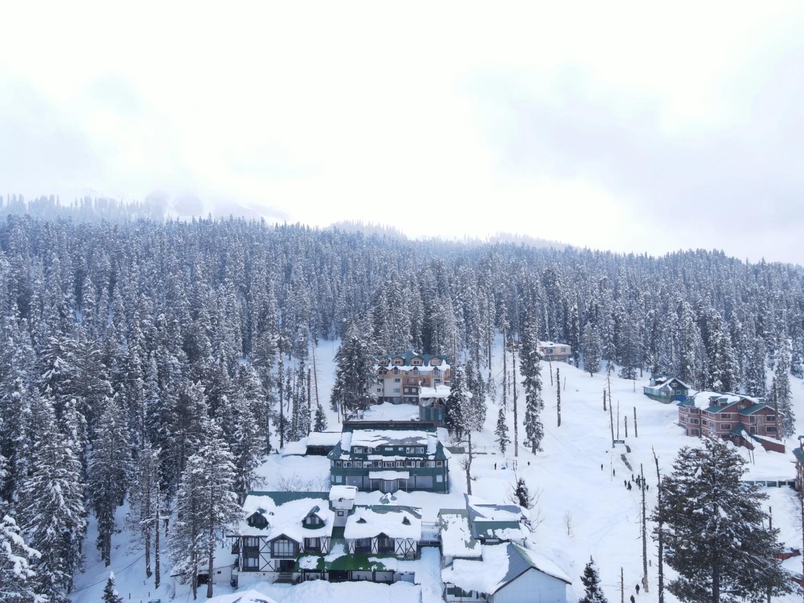 Aerial view of Gulmarg covered in snow, showcasing a serene winter wonderland