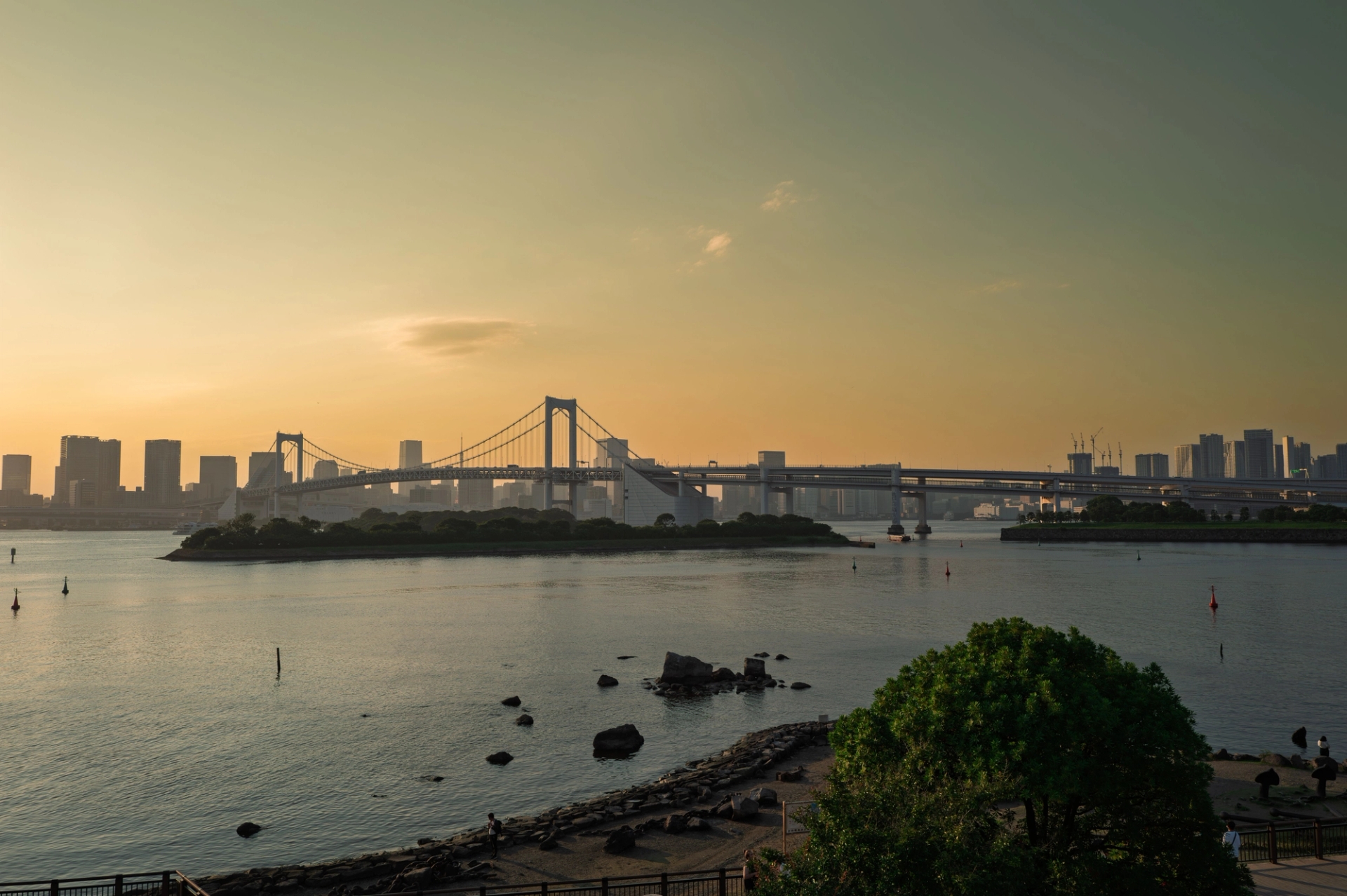 Beautiful sunset over Tokyo Bay with the iconic Rainbow Bridge and skyline in view