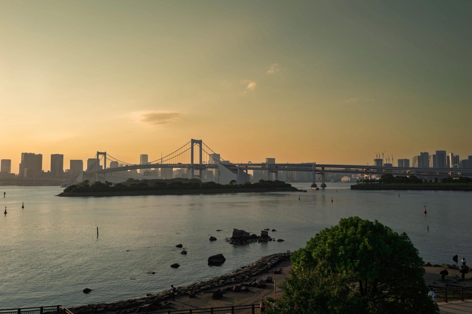 Beautiful sunset over Tokyo Bay with the iconic Rainbow Bridge and skyline in view
