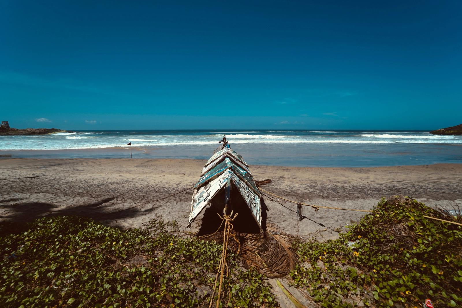 Captivating scene of a traditional fishing boat on the pristine Kovalam beach, Kerala, India