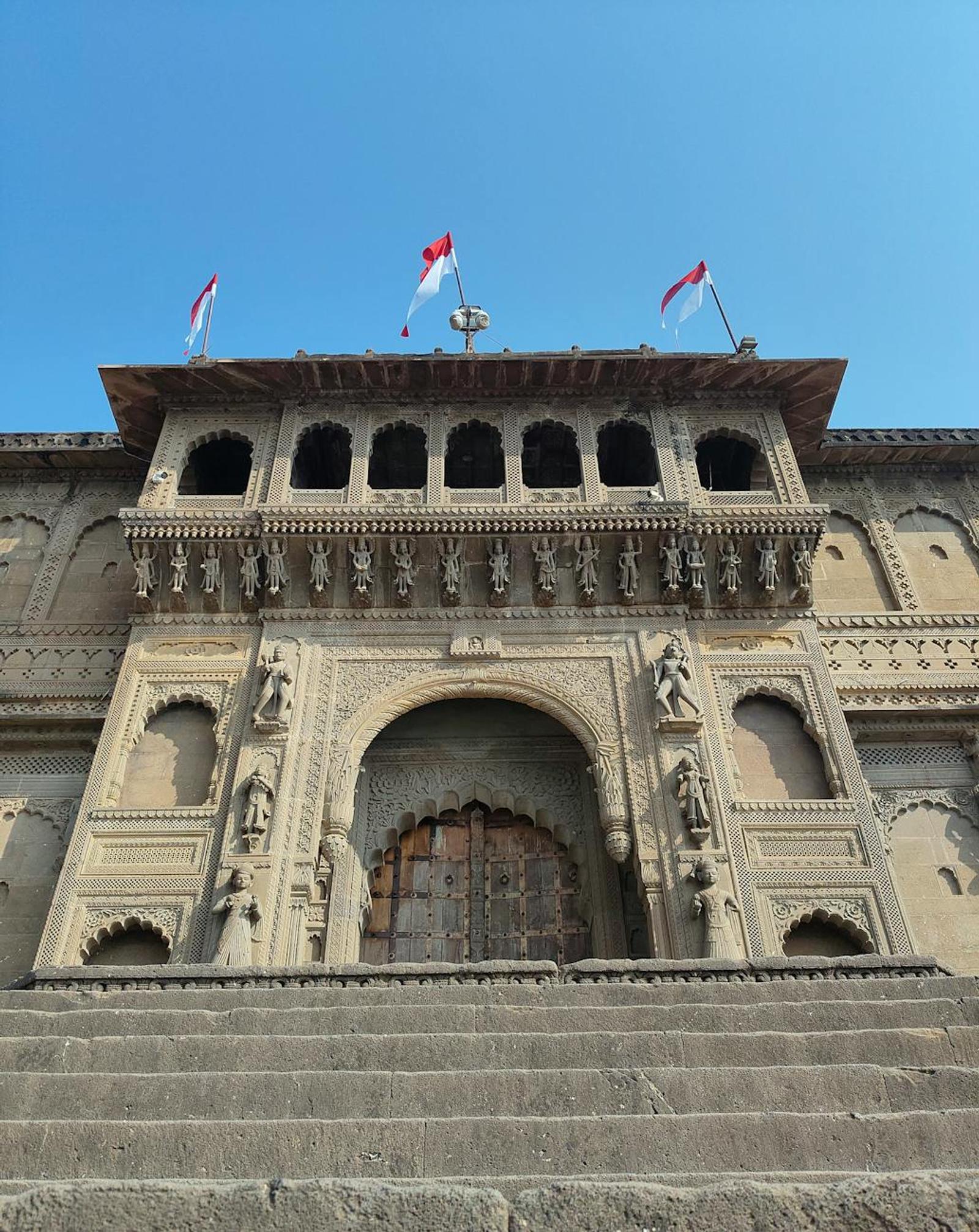 Majestic view of Maheshwar Fort showcasing intricate architecture under clear blue skies