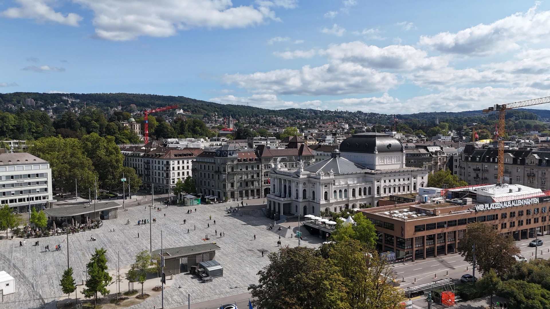 Stunning aerial view of Zürich's Opera House, surrounded by urban architecture and lush greenery