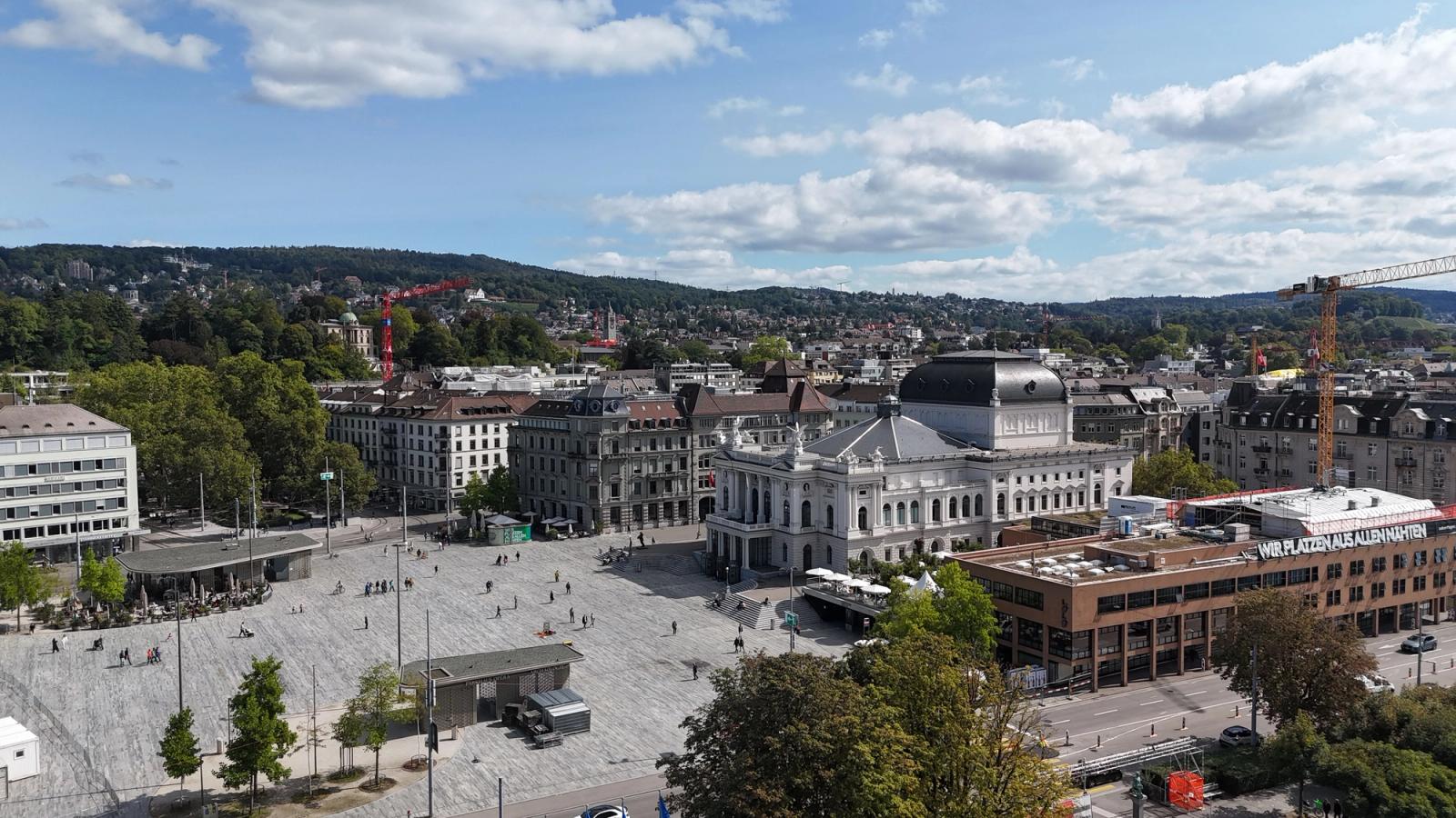 Stunning aerial view of Zürich's Opera House, surrounded by urban architecture and lush greenery