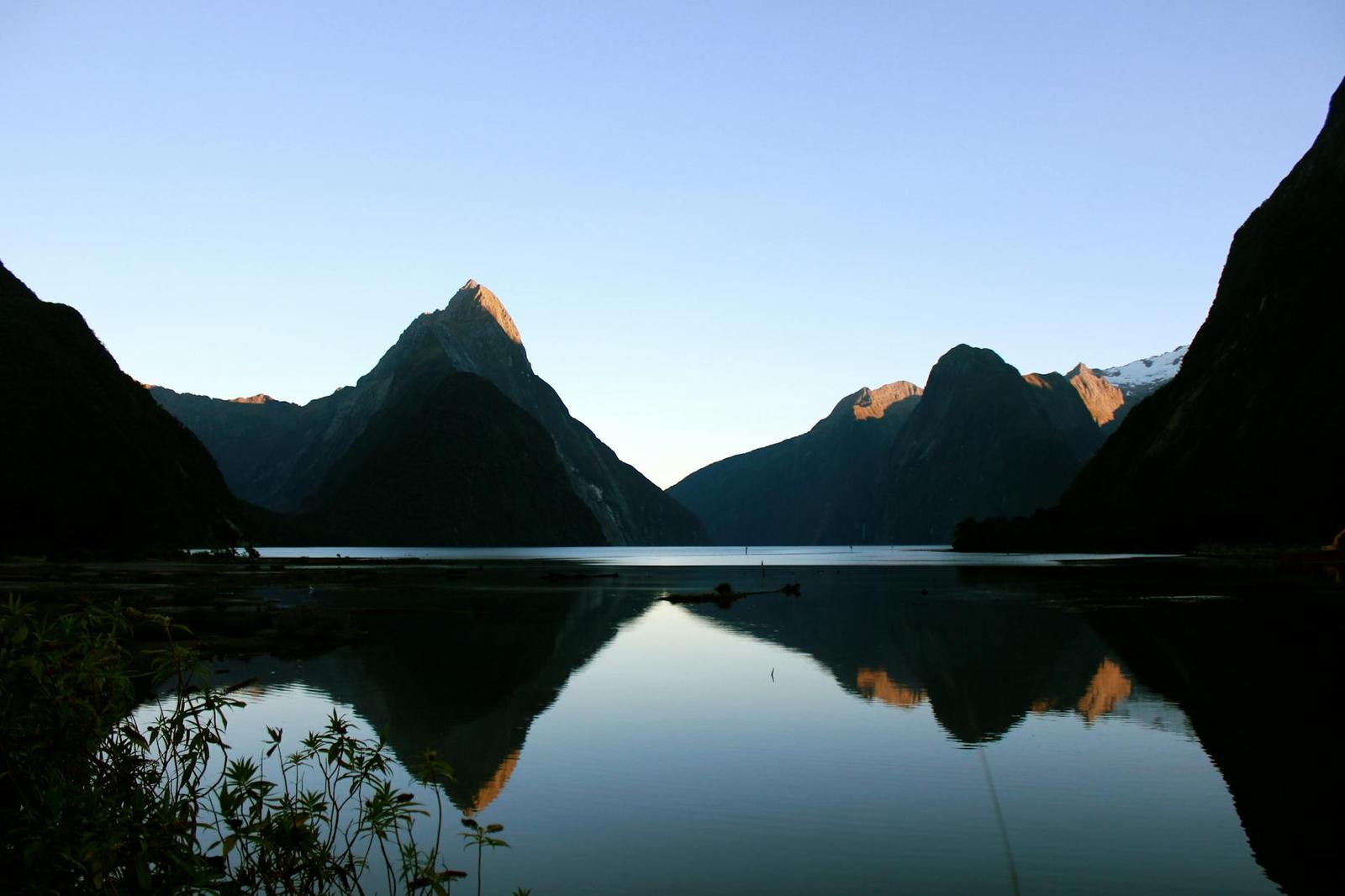Serene view of Milford Sound, New Zealand with mountains reflected in calm waters