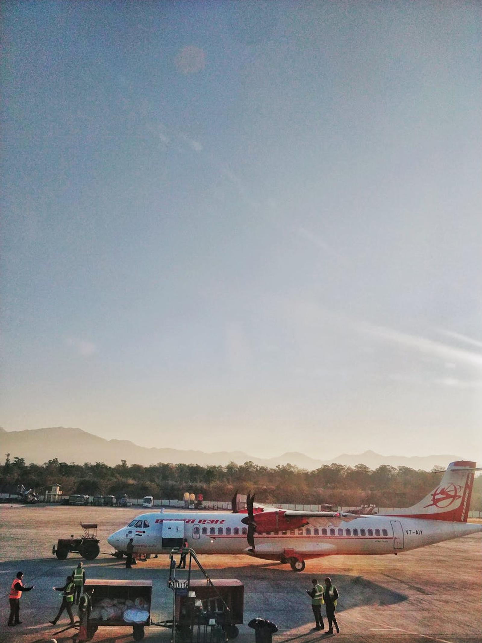 A scenic view of an airplane at Dehradun airport against a clear blue sky