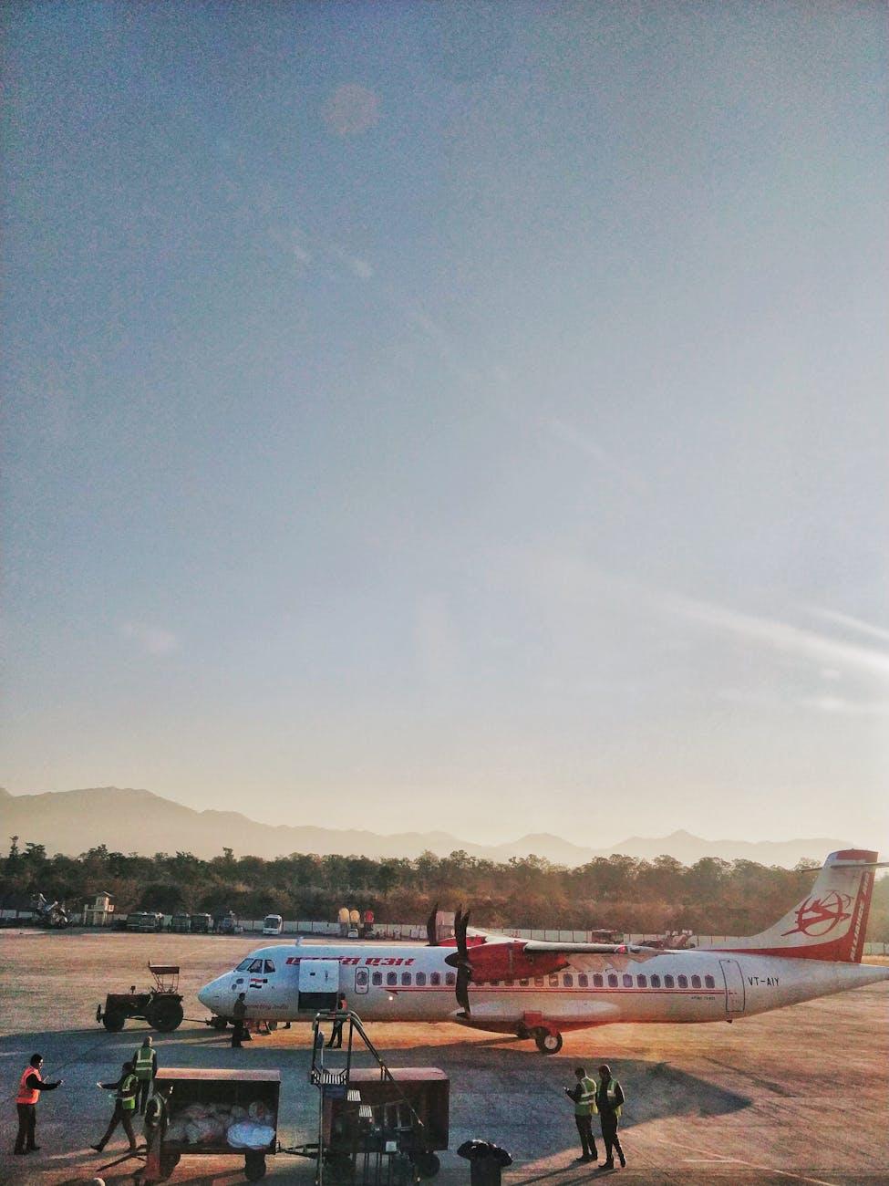 A scenic view of an airplane at Dehradun airport against a clear blue sky