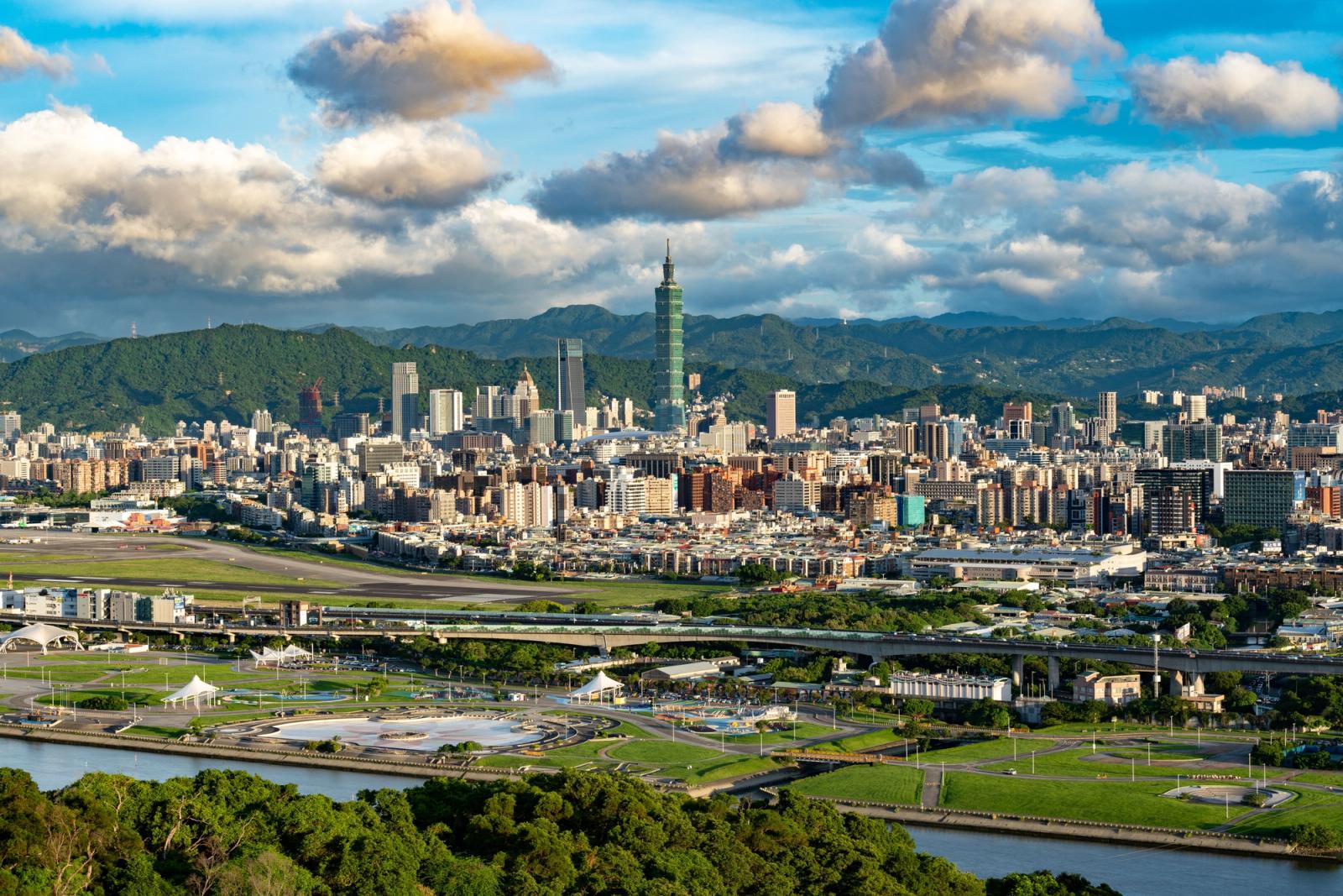 Scenic aerial view of Taipei city with Taipei 101 and mountains in the background