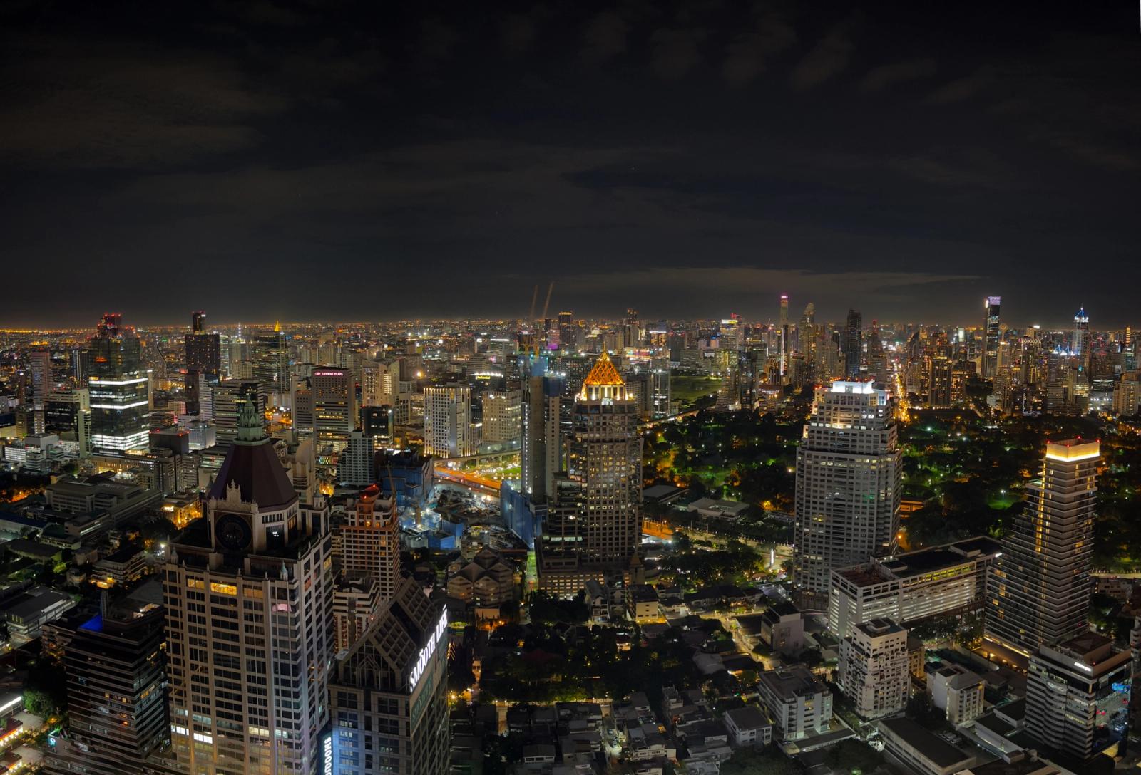 A breathtaking aerial view of Bangkok's vibrant cityscape illuminated at night