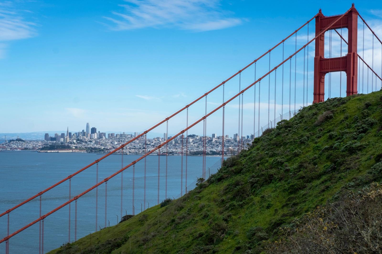 A scenic view of the Golden Gate Bridge with San Francisco skyline in the background