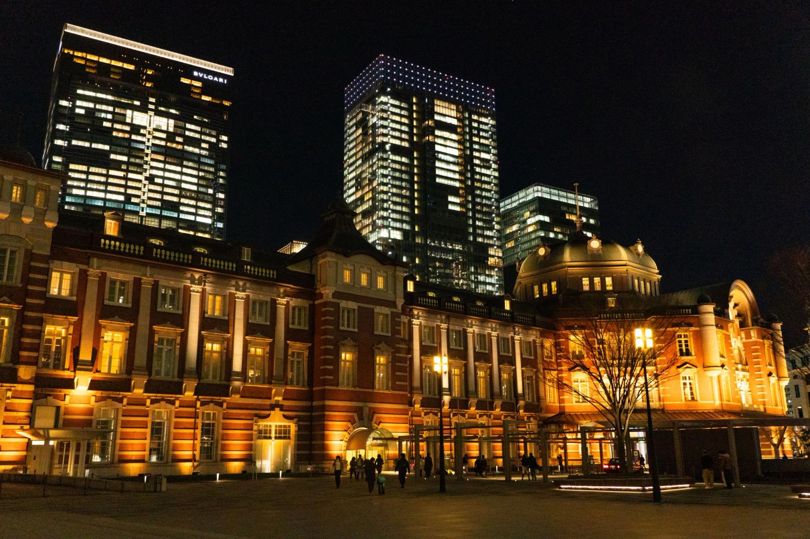 Night view of the historic Tokyo Station with modern skyscrapers in Chiyoda City, Japan